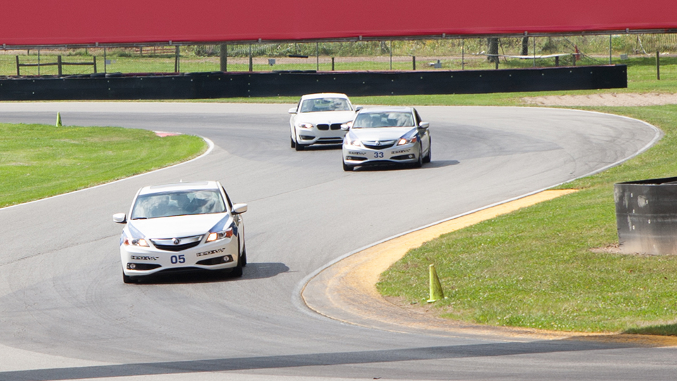 race cars from mid ohio racing school on road course