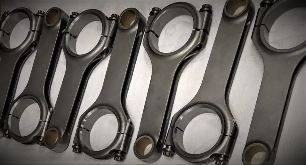 collection of connecting rods on a workbench