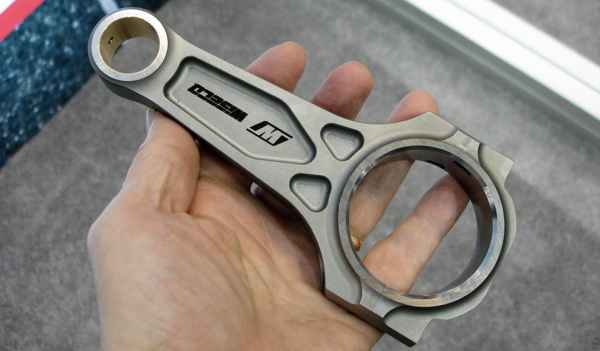 man holding a wiseco boostline connecting rod