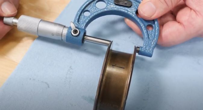 using a micrometer to measure thrust bearing