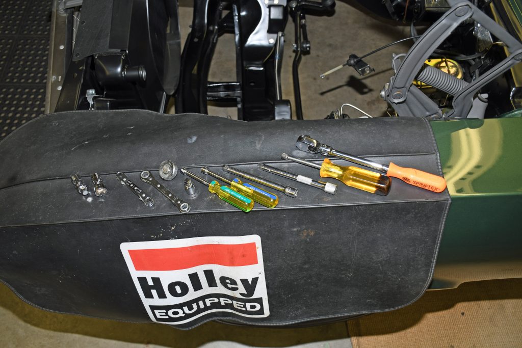 collection of tools on a holley fender cover