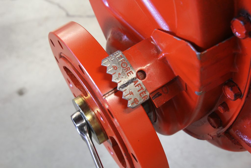 close up of timing mark and pointer on a vintage chevy small block v8 engine