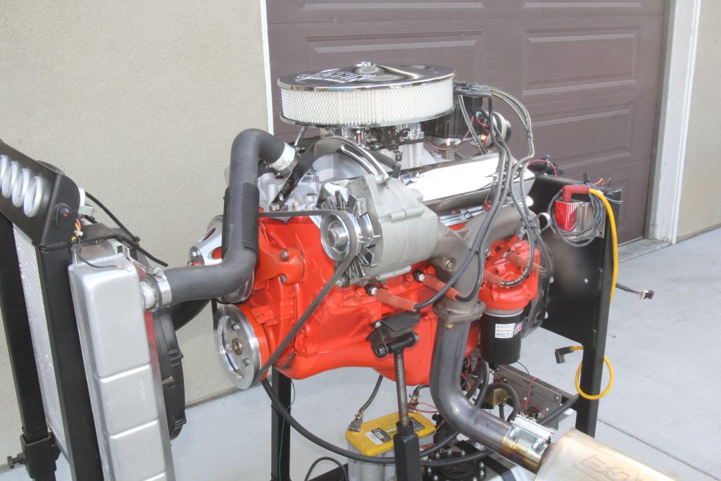 a chevy 283 small block engine on a run stand after being rebuilt