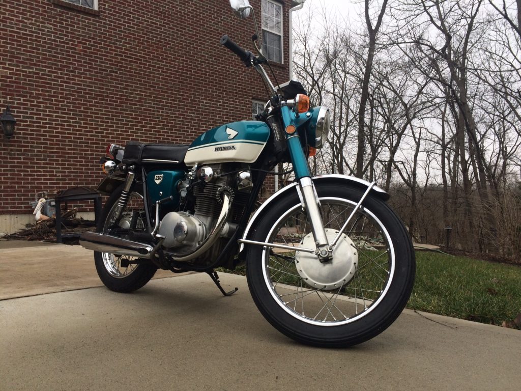 blue 1970 honda cb350 motorcycle in driveway