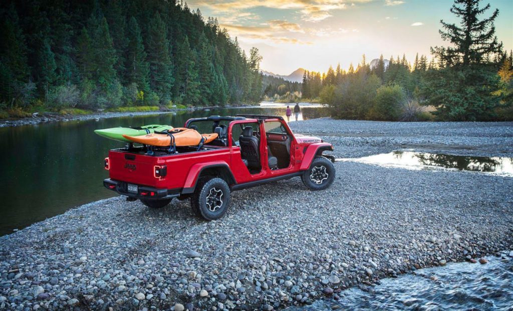 mopar jeep gladiator nexxt to lay with two kayaks installed on a bed rack carrier