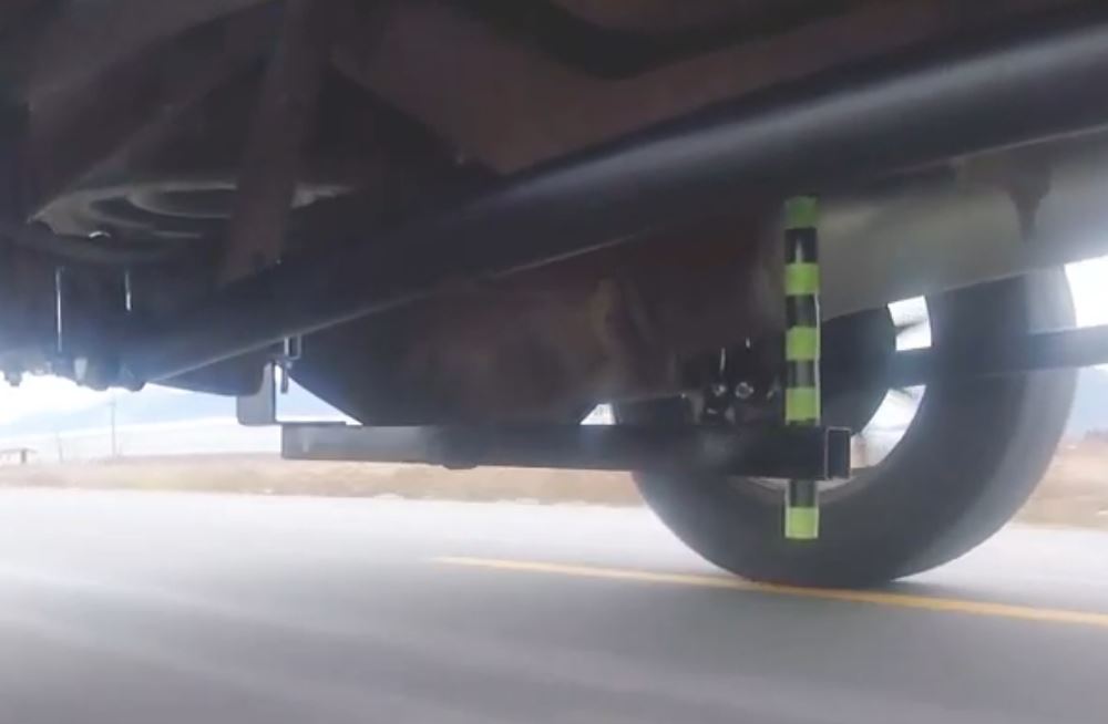 a look under a vehicle as its driven with a test jig to measure axle movement