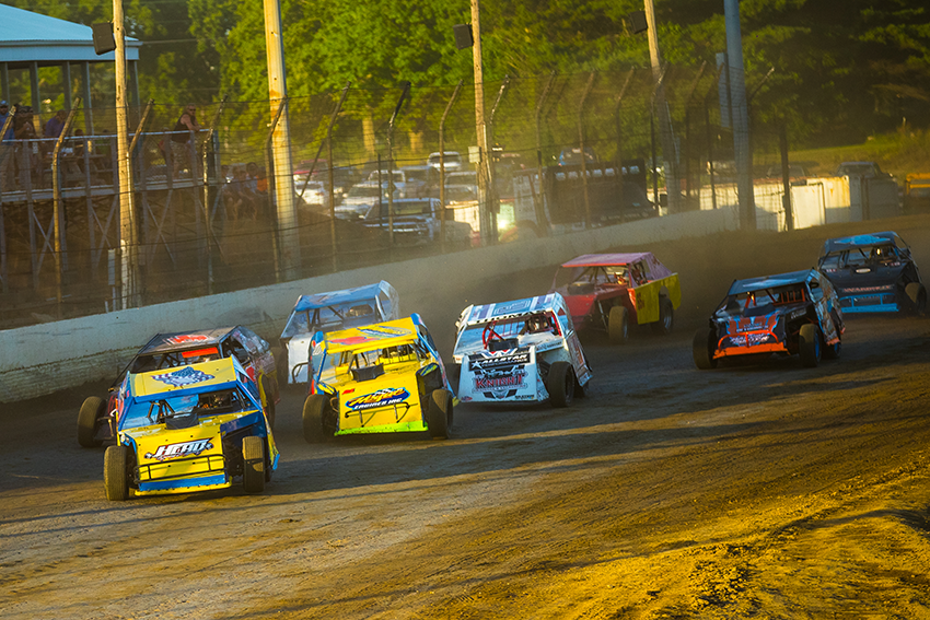 dirt car circle track racers running on a dirt track