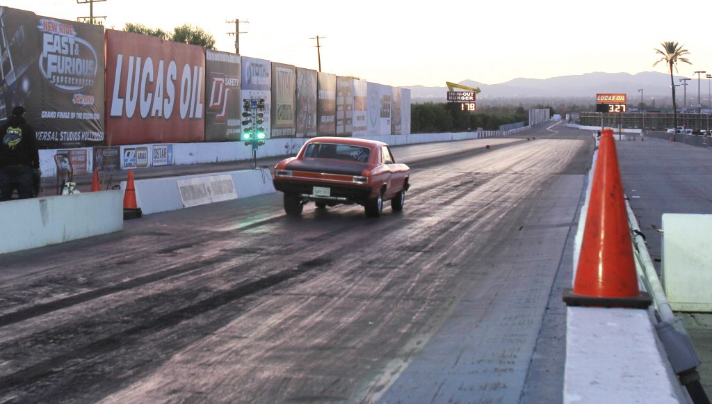 a 1966 chevy chevelle launching at a dragstrip