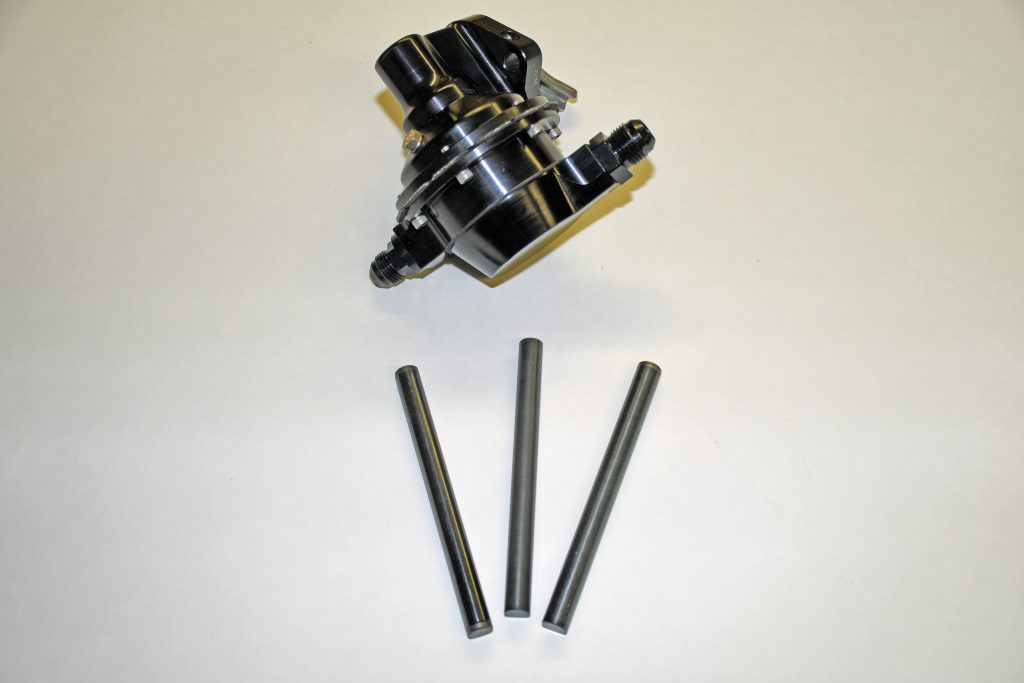 a mechanicalengine fuel pump next to 3 pushrods