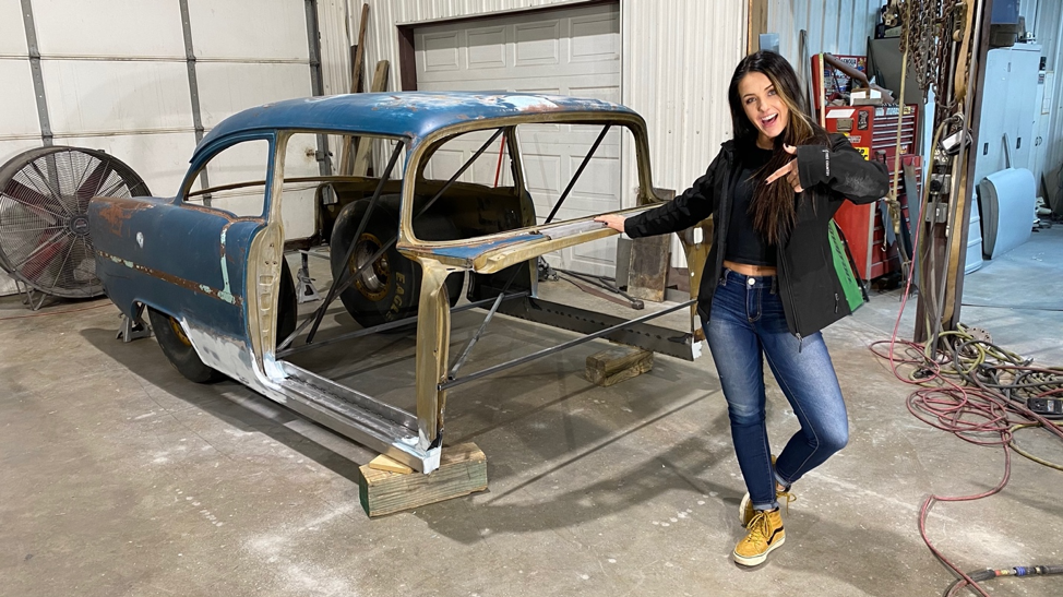 alex taylor poses with body shell of a 1955 chevy bel air drag race project