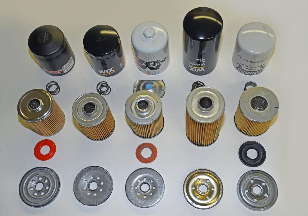 a collection of dissected engine oil filters on a table top