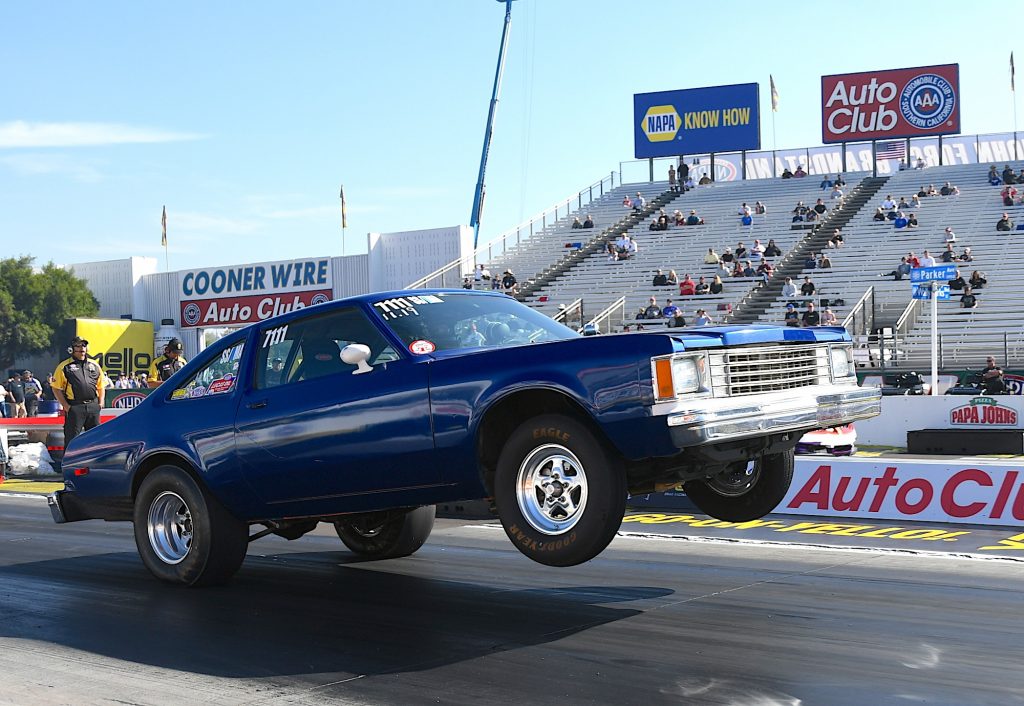 modified ddge aspen race car does a wheelstand at an nhra drag racing event