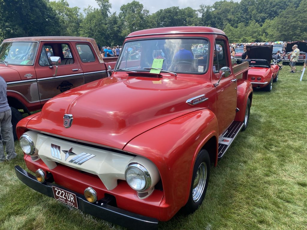 red 1954 ford f-100 at outdoor car show