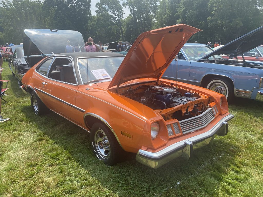 orange 1978 ford pinto at outdoor car show