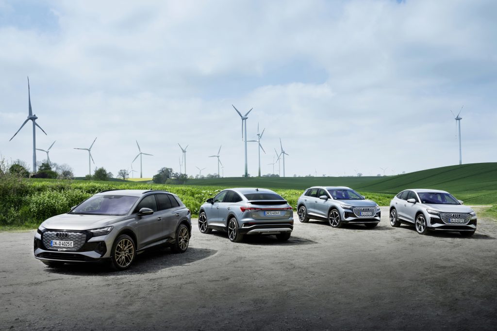 audi electric vehicles in front of windmill wind farm