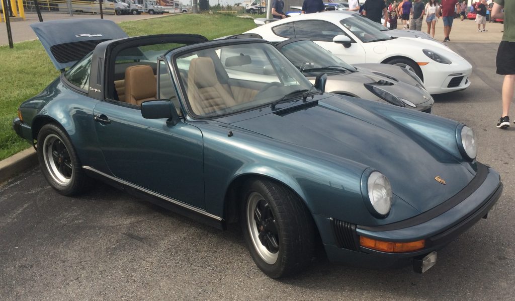 dark green air cooled Porsche 911 at a car show