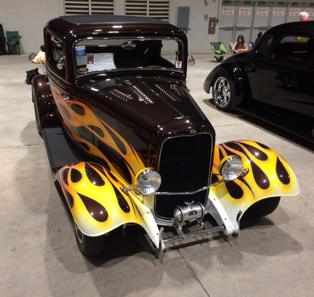 black hotrod with flamed paint job and louvered hood