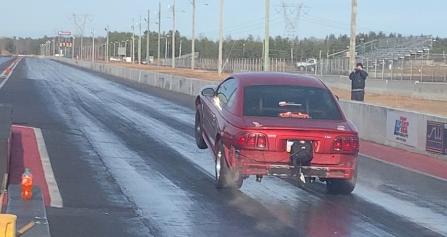 sn95 ford mustang launching at a dragstrip
