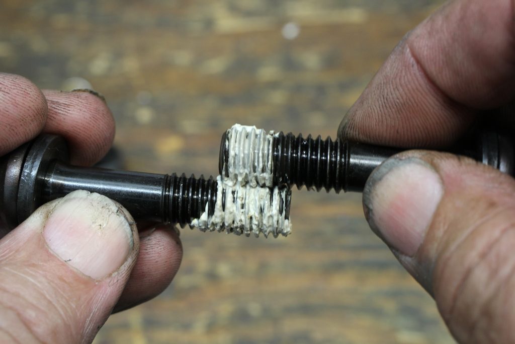 applying thread sealant to cylinder head intake bolts