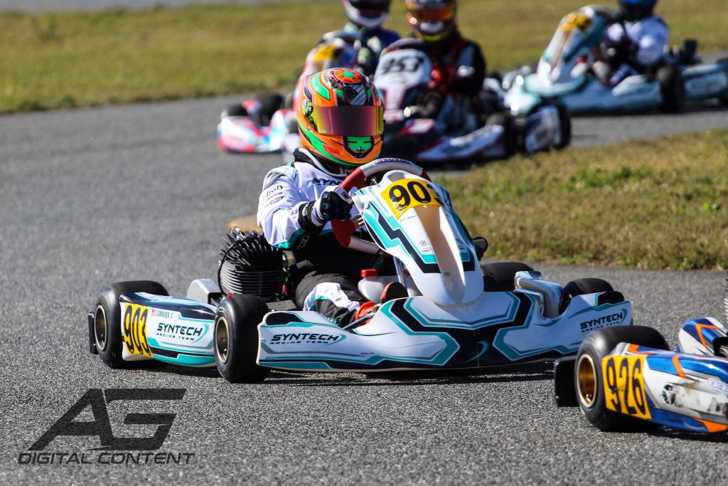 close up of a racer in a sprint kart racing around a karting track