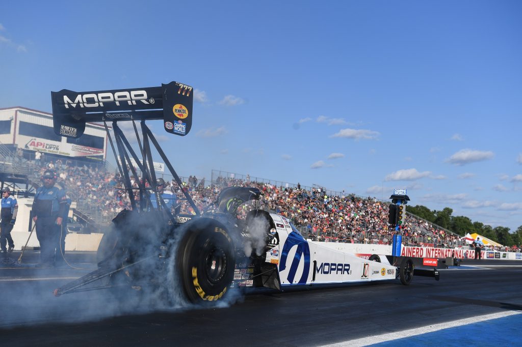 top fuel dragster does a burnout at the 2021 lucas nhra nationals