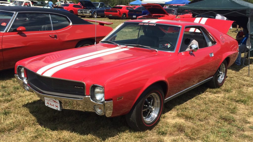 red amc amx with twin white racing stripes
