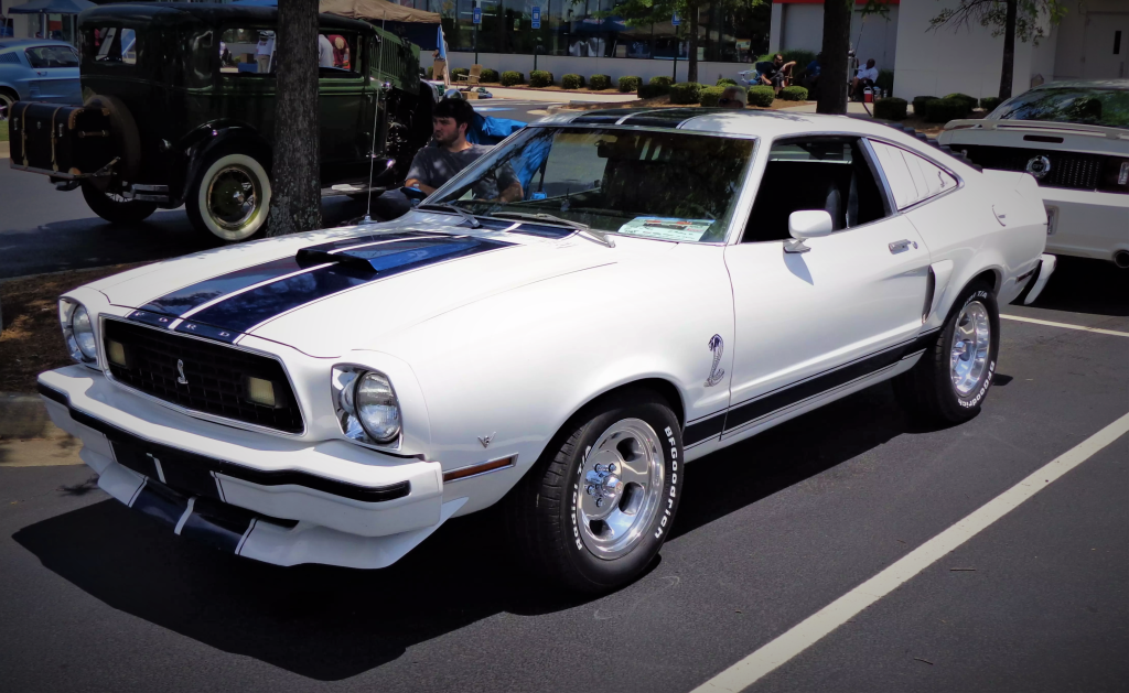 ford mustang cobra ii parked at a car show