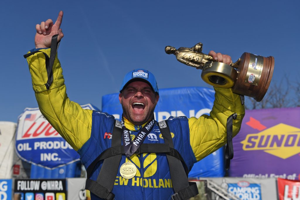 nhra funny car driver matt hagan holds wally trophy at 2021 midwest nationals