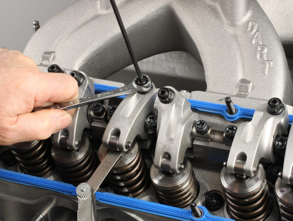 setting valve lash on a set of rocker arms in a cylinder head for a small block chevy engine