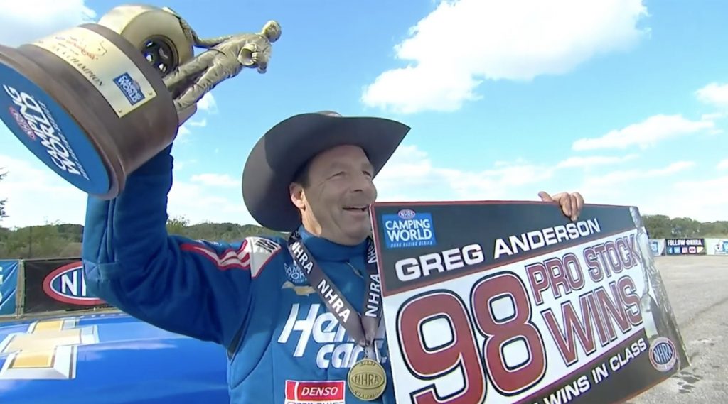 greg anderson holds up wally to celebrate 98 NHRA Pro Stock Wins