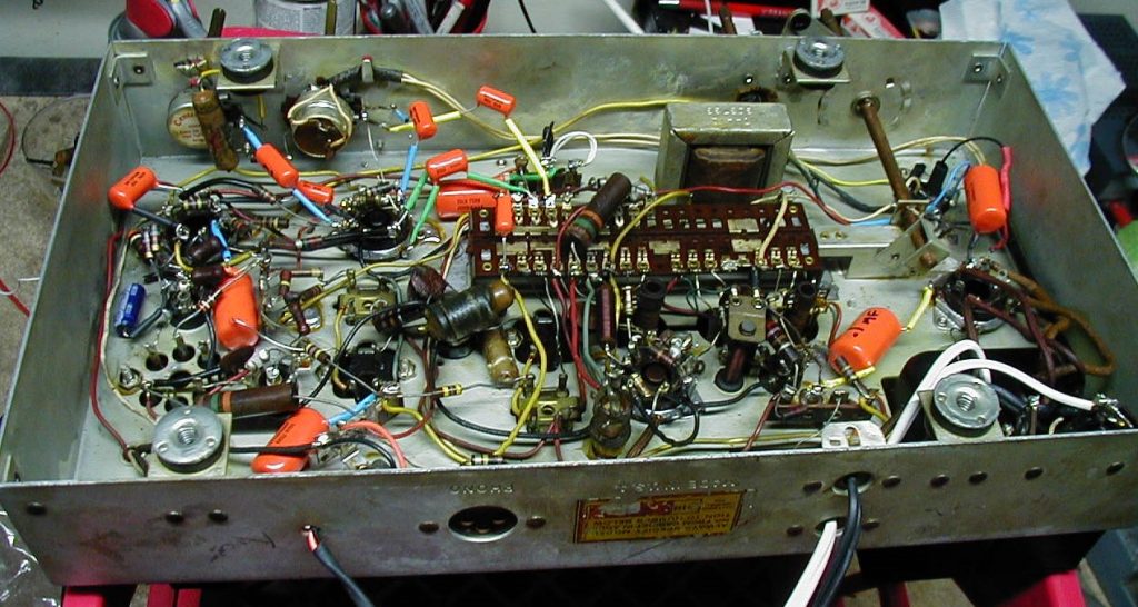 underside chassis view of vintage admiral tube radio and amplifier