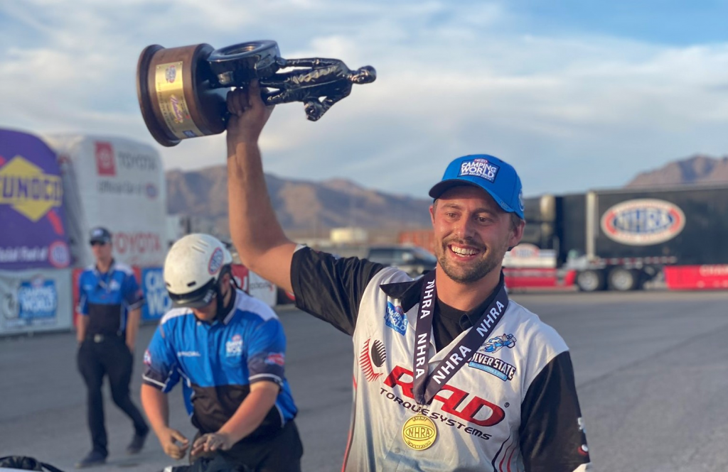 dallas glenn nhra pro stock driver holding wally trophy in las vegas