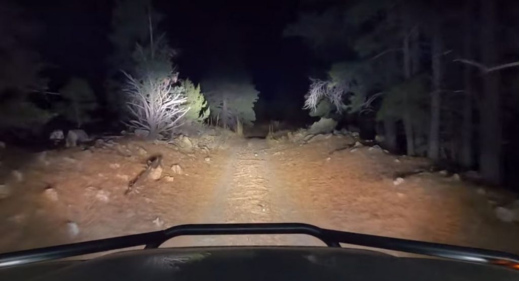 off road trail illuminated by auxiliary lights