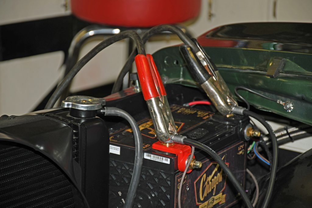 pair of jumper cables attached to hot rod battery for jumpstart and charging