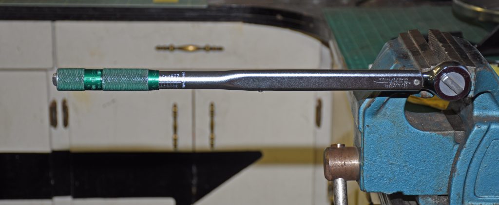 torque wrench head locked in a bench vise prior to calibration and testing