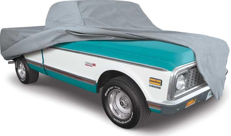 vintage chevy c10 pickup truck under a gray car cover