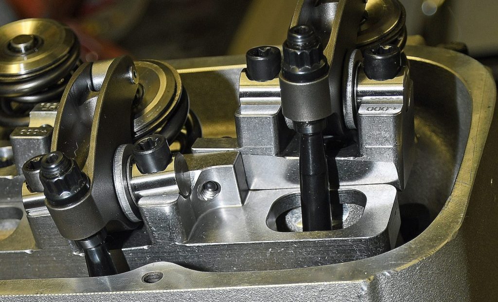 close up of engine pushrods installed in a cylinder head