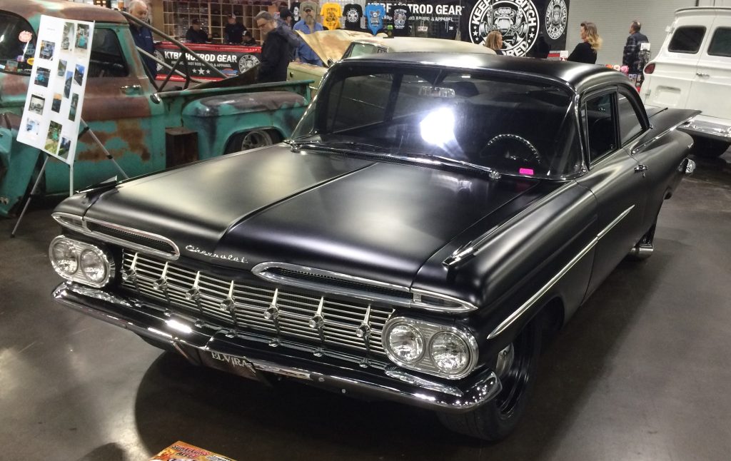 1959 chevy Biscayne with flat black paint job at indoor car show