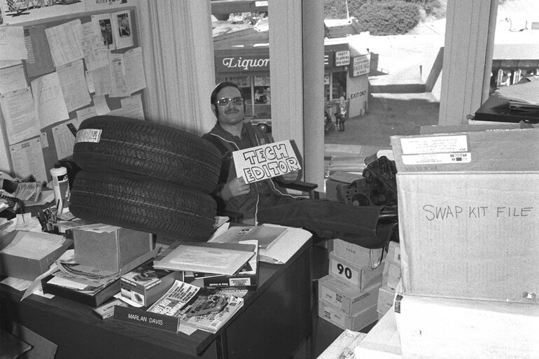 vintage photo of hot rod car craft tech editor marlon davis sitting at old desk