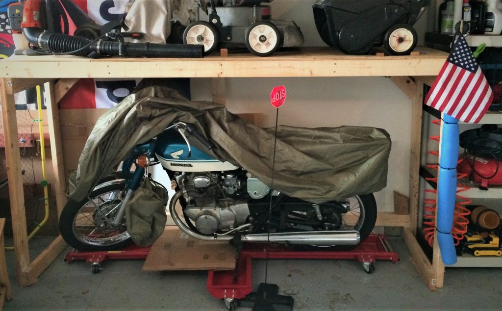 honda cb350 vintage motorcycle covered in garage