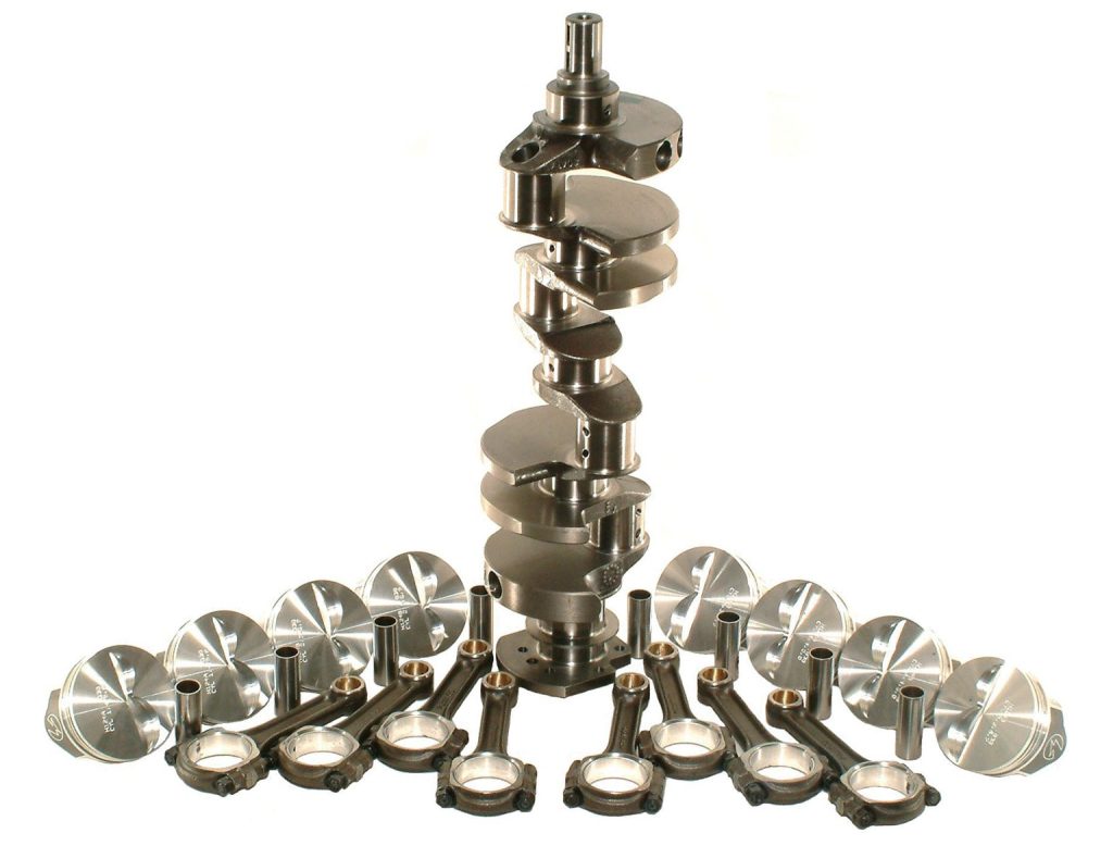 summit racing stroker kit arranged on a white background with crankshaft, pistons and connecting rods