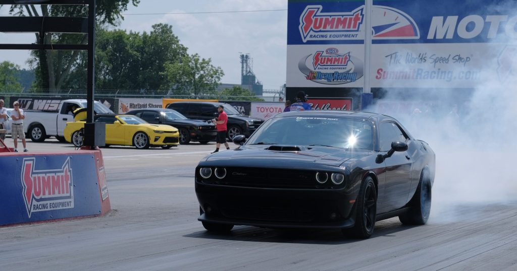 dodge challenger shaker doing a burnout at summit motorsports park drag strip