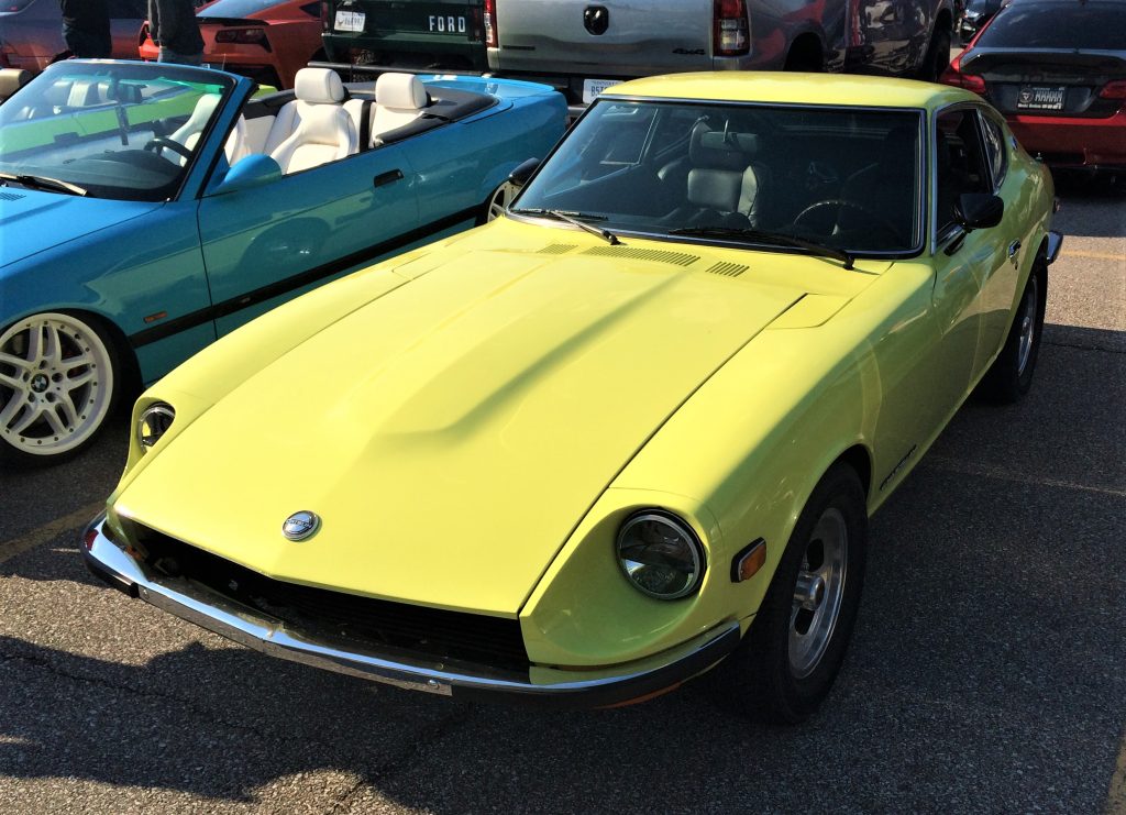 yellow nissan datsun 240z front at a car show