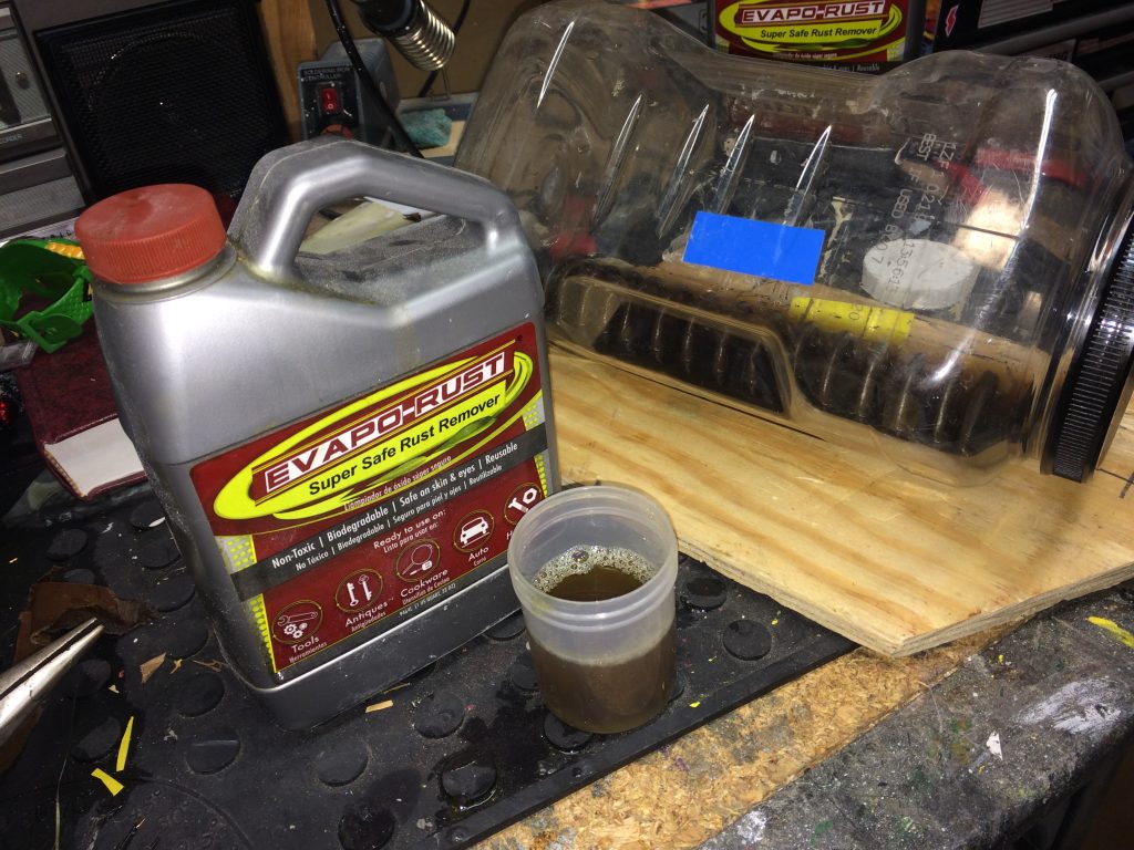evaporust jug on workbench with rusty honda cb350 fork spring