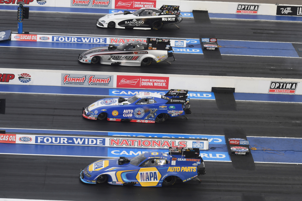 shot of funny cars racing side by side at las vegas 4 wide nhra nationals in 2022