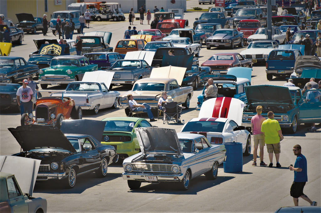 collection of spectators and classic vintage cars at super summit vintage car show