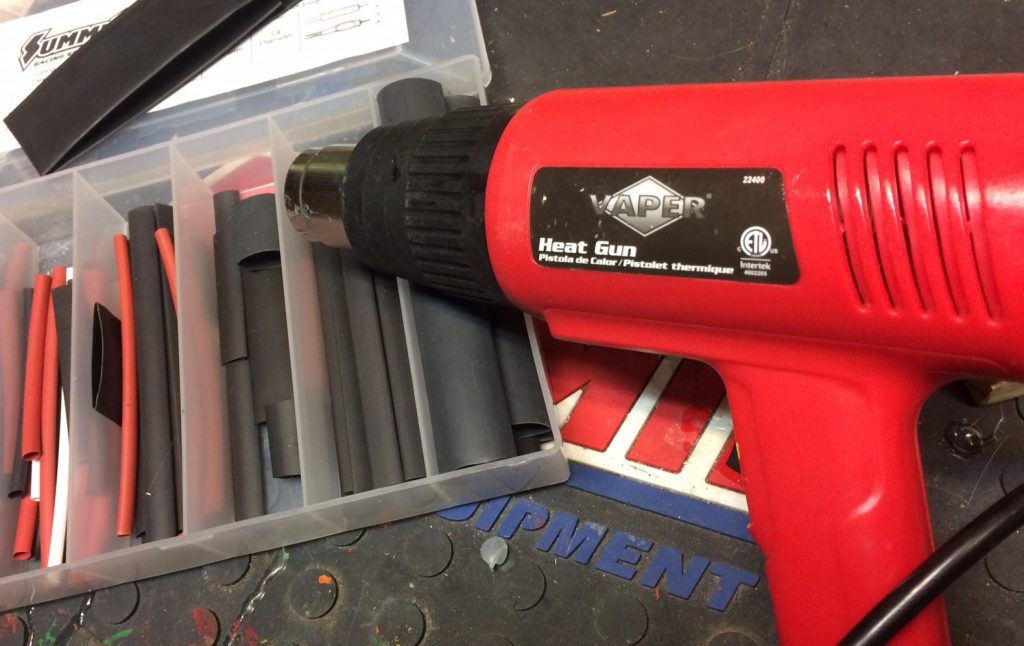vaper heat gun from titan tools on workbench next to box of heat shrink tubing