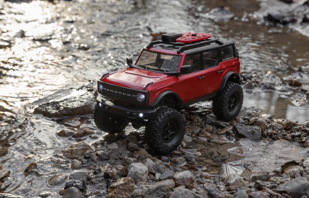 axial red ford bronco radio controlled rc truck crossing creek bed