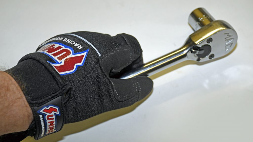man's hand wearing summit racing mechanics glove gripping socket wrench