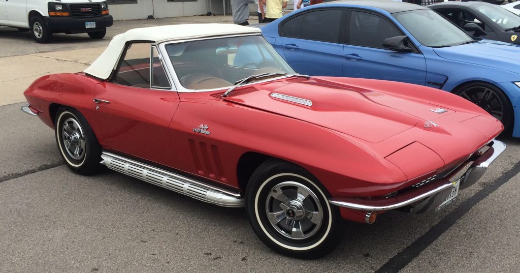 1966 chevy corvette c2 sting ray convertible at a classic car show with 427 big block engine